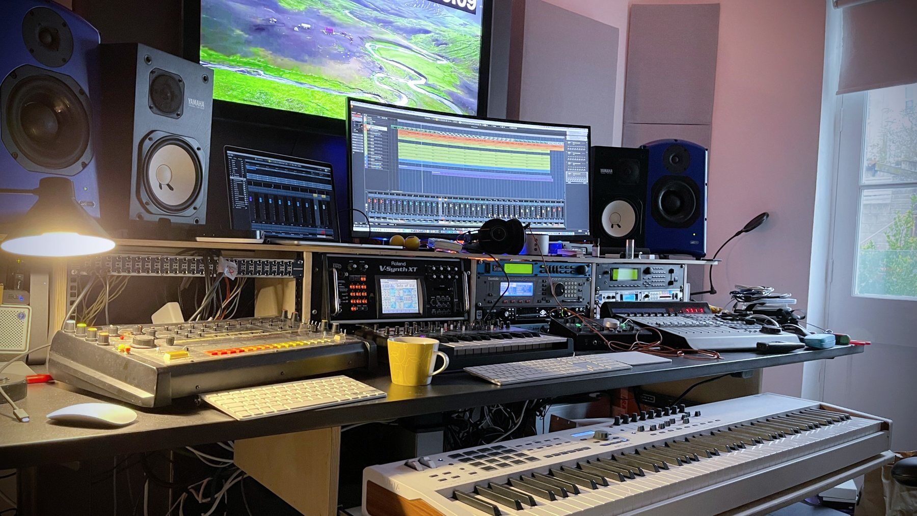 Jonny Gunton's Bristol scoring studio, picture monitor showing timecode above the mixing desk and synths